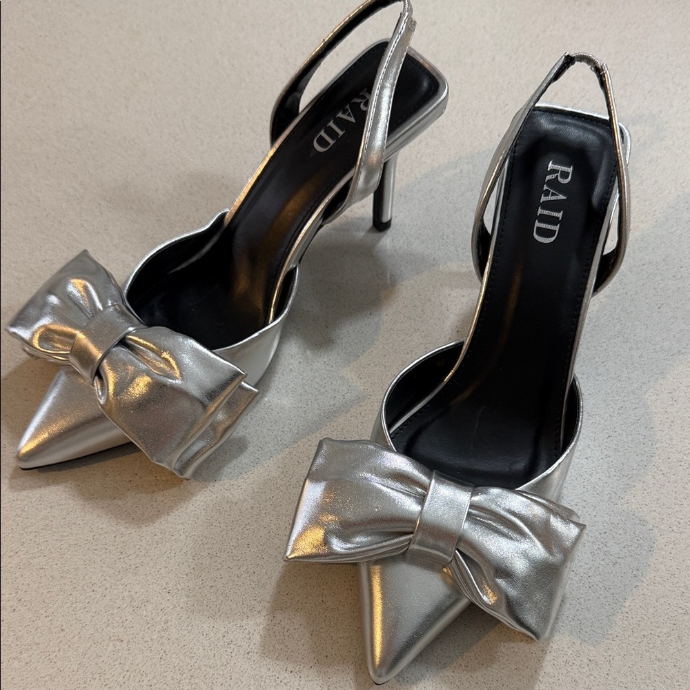 Brand New RAID Silver Bow Heels